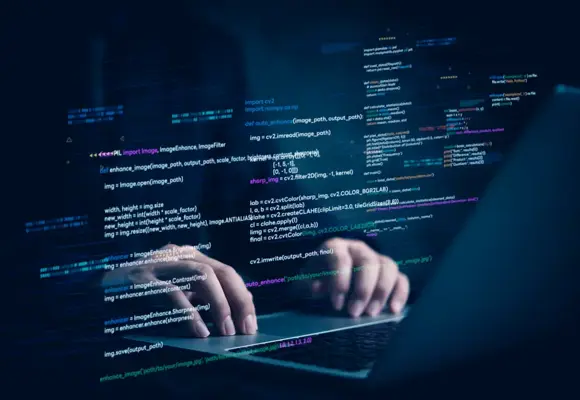 Hands typing on laptop