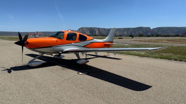 Orange airplane sitting on a runway