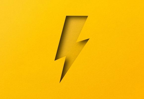 illustration of yellow lightning symbol cut from yellow paper