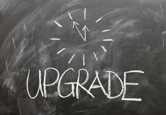 chalkboard with the word "upgrade" and a clock hands written in chalk